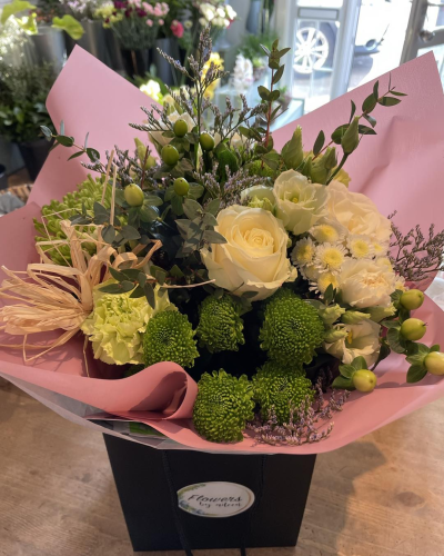 Blush Garden - A soft arrangement that captures a natural, garden-inspired charm. Nestled in delicate blush wrapping, this bouquet blends fresh greenery with gentle textures and subtle pops of creamy tones. The combination of airy stems, rounded accents, and layered foliage creates a balanced, organic look that feels both modern and timeless. Perfect for celebrating special moments or simply bringing a sense of calm beauty into any space.
