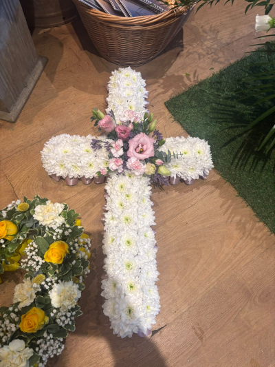 Cross - A traditional cross tribute with a delicate central spray, thoughtfully designed as a symbol of love, faith and remembrance.